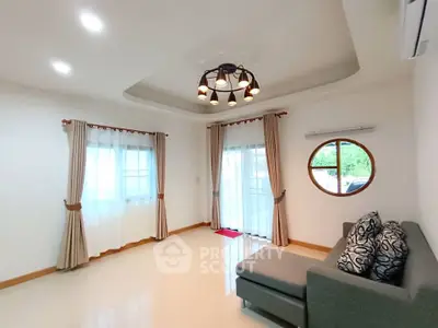 Spacious living room with modern lighting and large windows