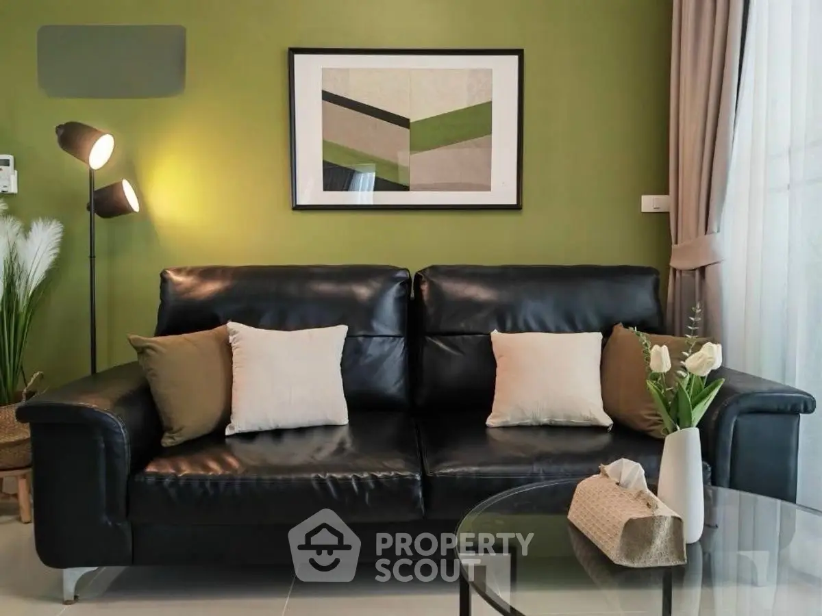 Stylish living room with black leather sofa and modern decor