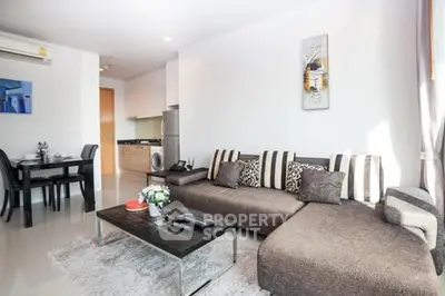 Modern living room with stylish sofa and dining area in open layout apartment.