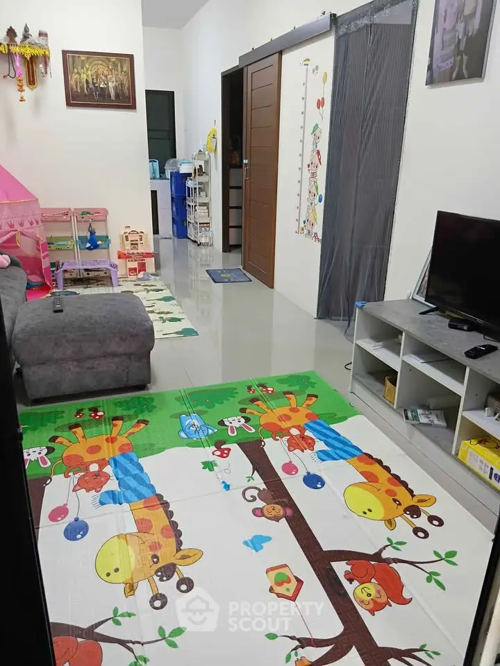 Charming family living room with playful decor and cozy seating area.