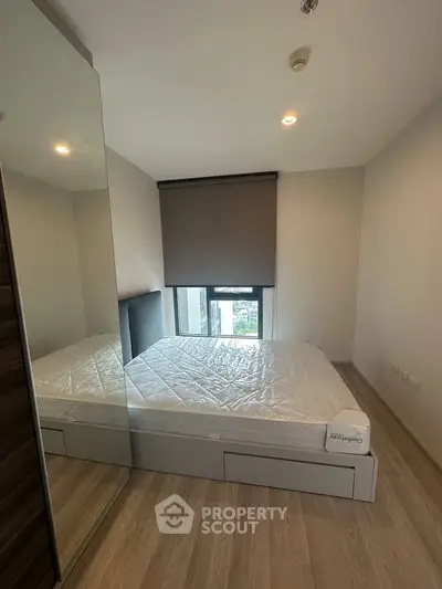 Modern bedroom with large mirror and natural light