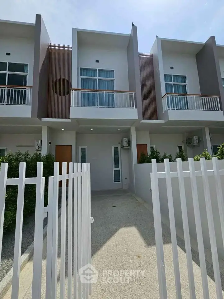 Modern townhouse exterior with sleek design and private entrance, perfect for urban living.