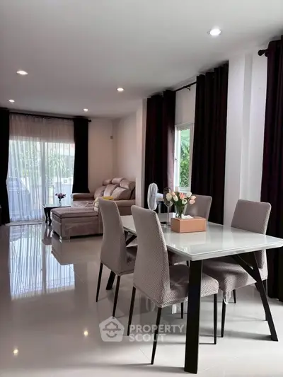 Spacious modern living and dining area with elegant decor and natural light.