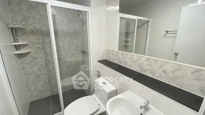 Modern bathroom with glass shower and sleek fixtures