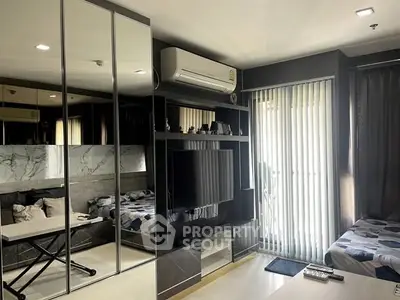 Modern living room with mirrored wardrobe and sleek TV unit in stylish apartment.