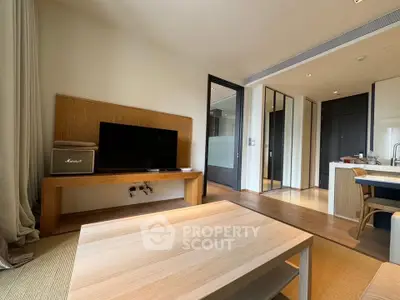 Modern living room with sleek wooden furniture and open kitchen layout
