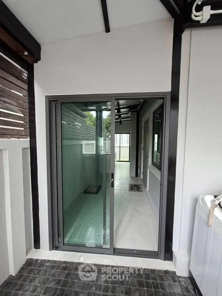 Modern exterior with sliding glass door and sleek design