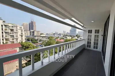 Spacious balcony with city view in modern apartment, perfect for relaxation and enjoying urban skyline.