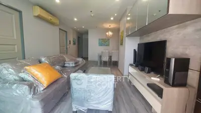 Modern living room with sleek furniture and entertainment center, perfect for relaxation and entertainment.
