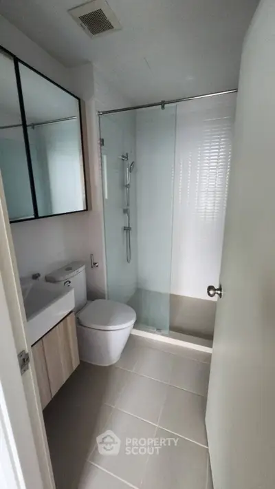 Modern bathroom with glass shower and sleek fixtures