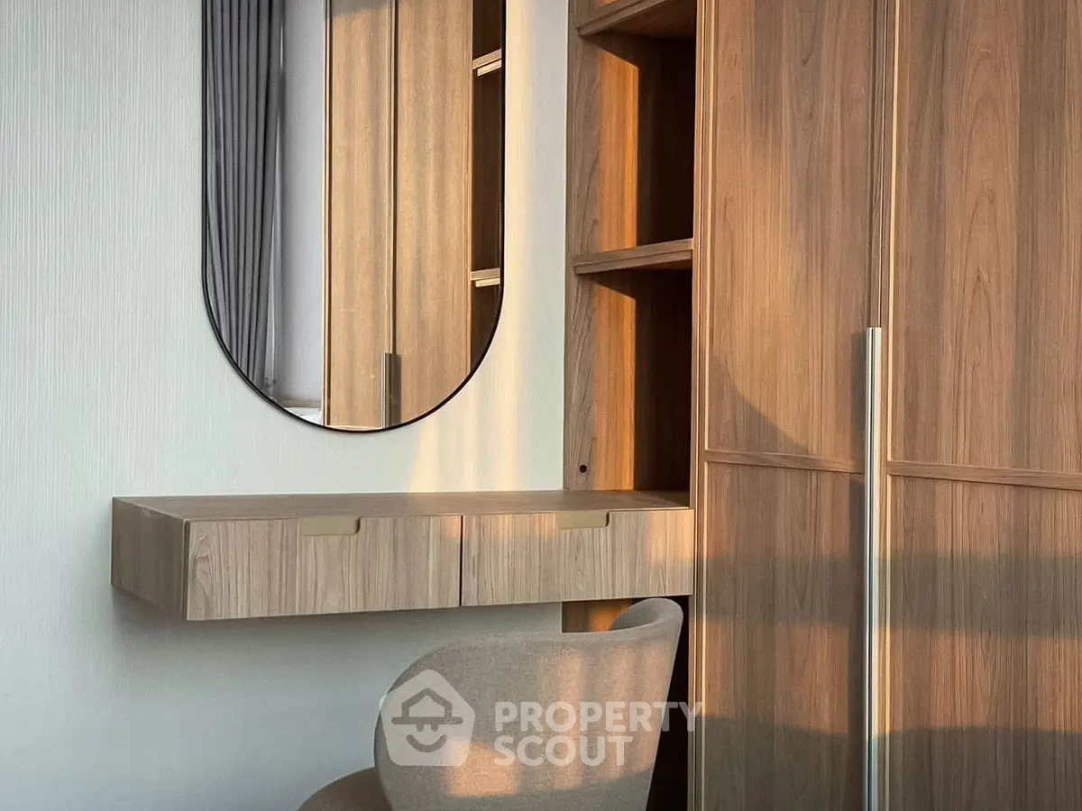 Modern bedroom with stylish wooden wardrobe and elegant vanity mirror