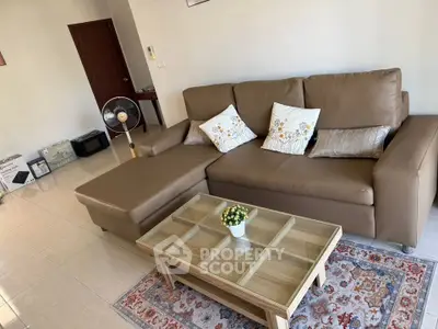 Spacious living room with modern brown leather sofa and elegant glass coffee table.