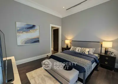 Luxurious bedroom with elegant decor and modern furnishings, featuring a plush bed and stylish artwork.
