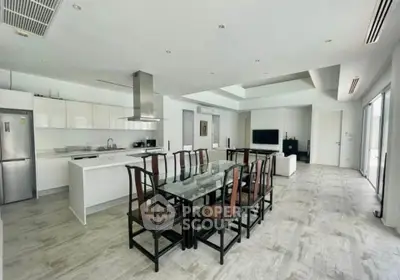 Spacious modern open-plan kitchen and dining area with sleek design and ample natural light.