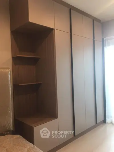 Modern bedroom with sleek built-in wardrobe and natural light