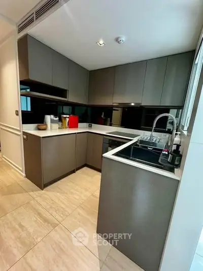 Modern kitchen with sleek cabinetry and integrated appliances in a stylish home.