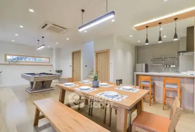 Spacious modern dining area with wooden furniture and open kitchen layout