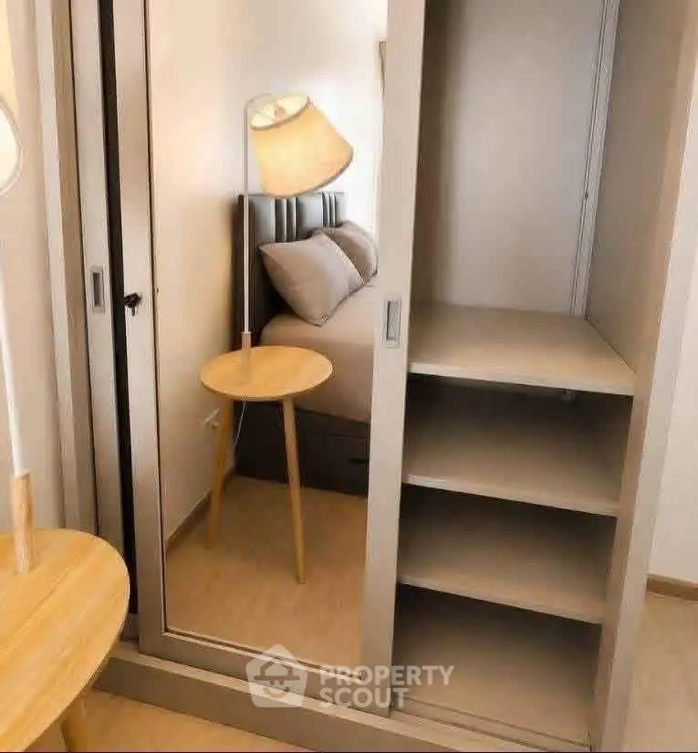 Modern bedroom with mirrored wardrobe and stylish lamp