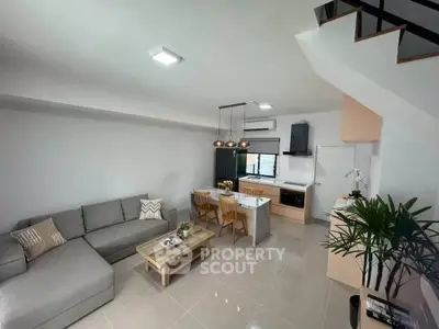 Modern living room with open kitchen and stylish decor