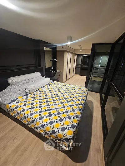 Modern bedroom with stylish decor and large windows offering ample natural light.