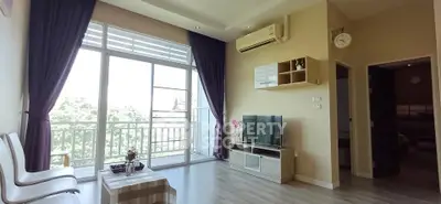 Spacious living room with large windows and modern decor in a bright apartment.