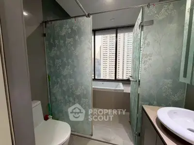 Modern bathroom with glass shower, bathtub, and city view window.