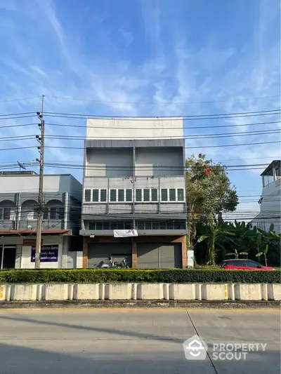 Modern commercial building with large windows and street view