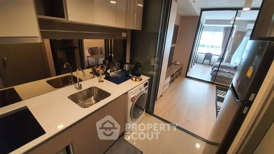 Modern apartment interior with sleek kitchen and cozy bedroom view