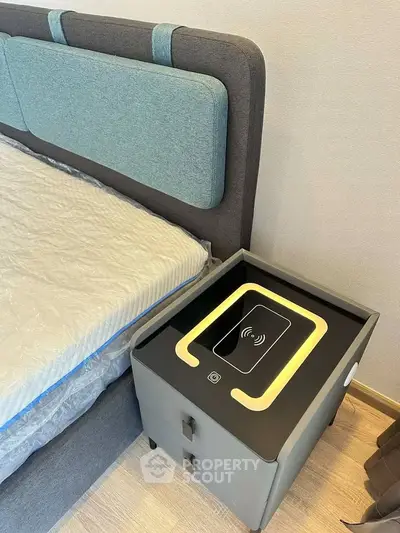 Modern bedroom with stylish headboard and smart nightstand featuring wireless charging.