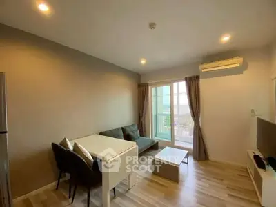 Modern living room with balcony, sleek furniture, and natural light