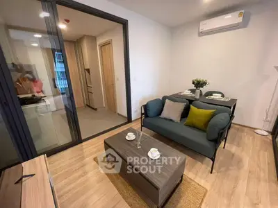 Modern living room with cozy seating and dining area in open layout apartment.