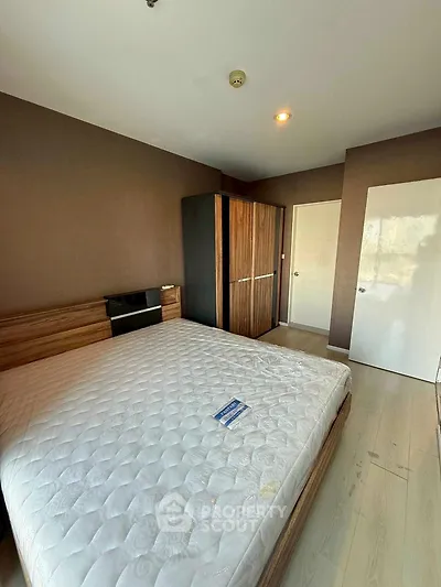 Modern bedroom with wooden wardrobe and large bed in a cozy apartment