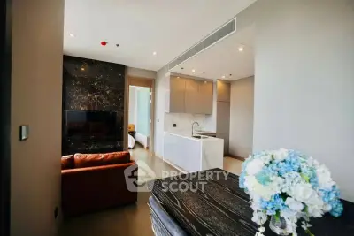 Modern open-layout living room with sleek kitchen and elegant decor