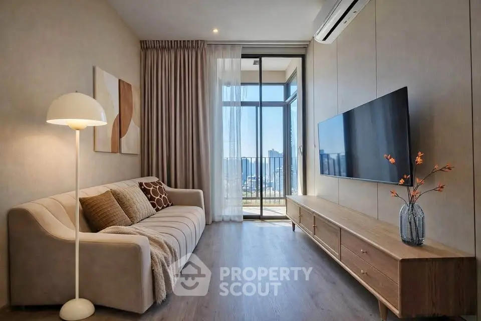 Modern living room with stylish decor and balcony view in luxury apartment.
