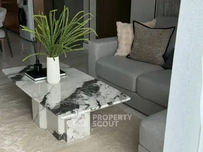 Stylish modern living room with marble coffee table and cozy gray sofa