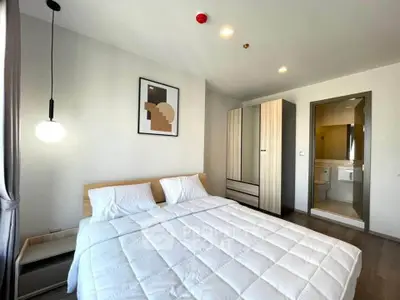 Modern bedroom with cozy double bed and stylish decor in a contemporary apartment.