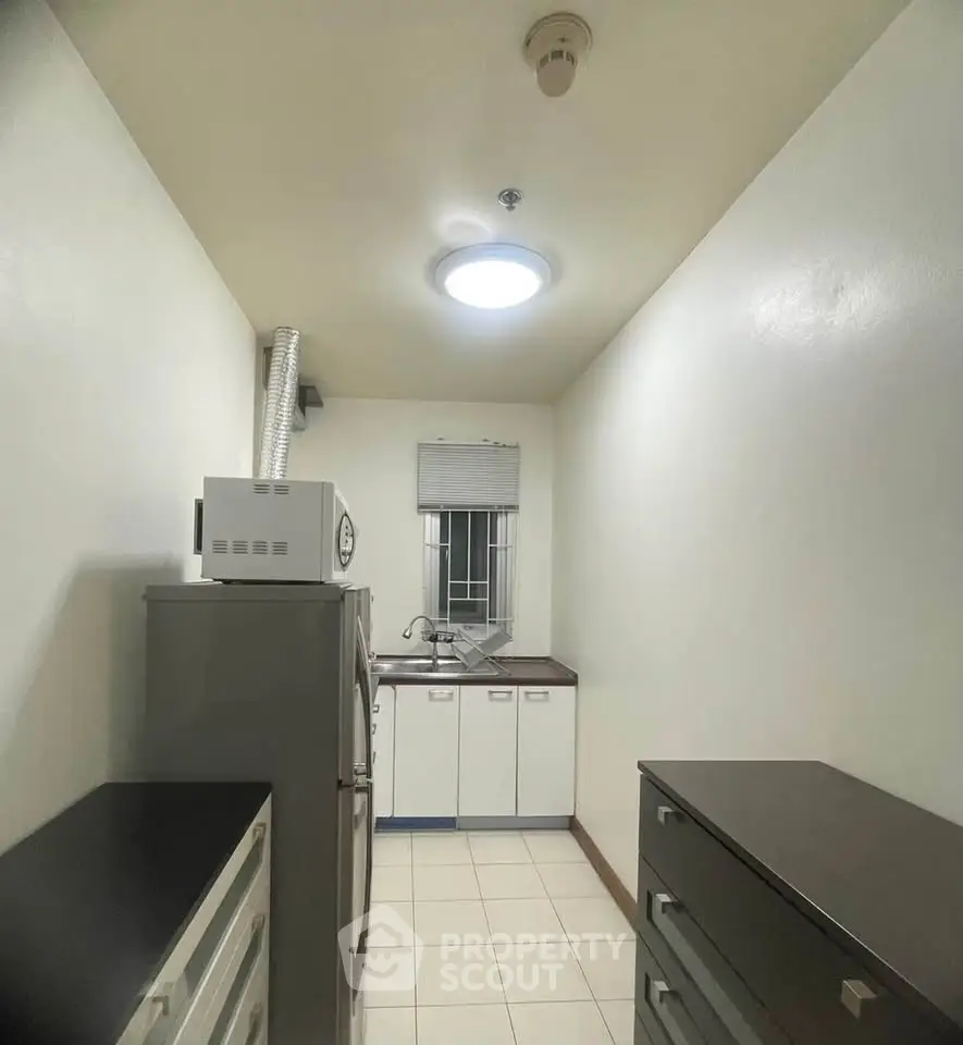 Compact kitchen with modern appliances and sleek cabinetry