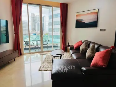 Modern living room with large windows and city view, featuring stylish furniture and decor.