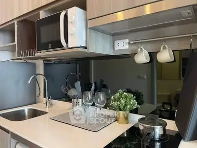 Modern kitchen with sleek appliances and stylish decor in a contemporary apartment.