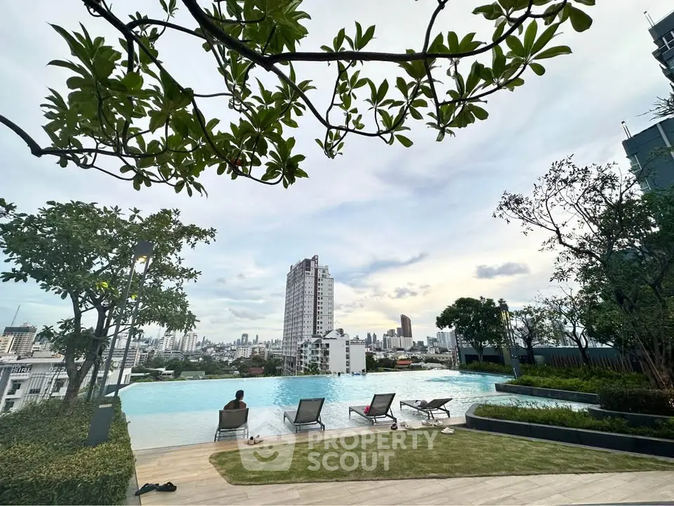 Stunning rooftop pool with panoramic city views and lush greenery