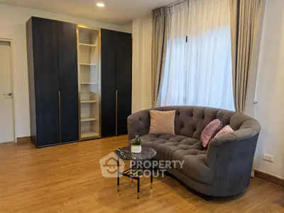 Stylish living room with elegant sofa and modern shelving unit, perfect for cozy relaxation.