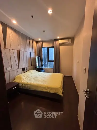 Modern bedroom with stylish wood paneling and cozy lighting