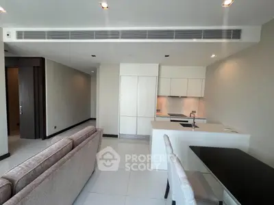 Modern open-plan living room with sleek kitchen and elegant furnishings