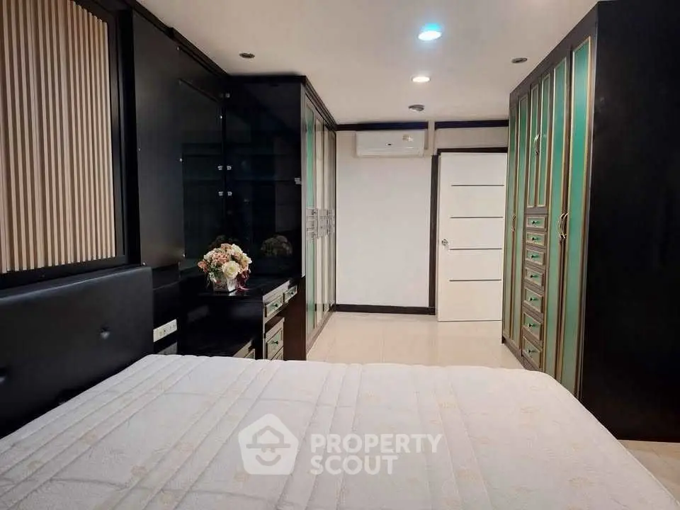 Luxurious bedroom with elegant decor and ample storage space.