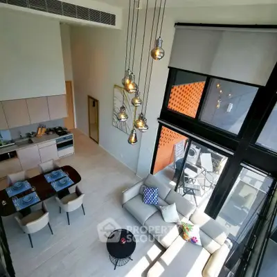 Stunning modern living room with high ceilings and elegant lighting in a luxurious apartment.