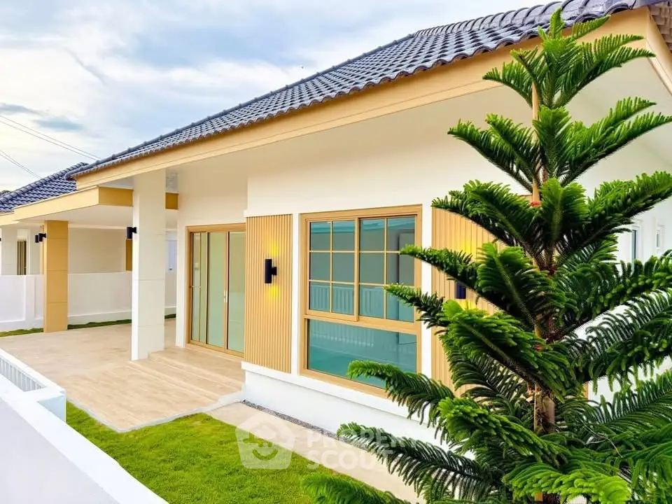 Charming modern house exterior with lush green lawn and stylish architecture.