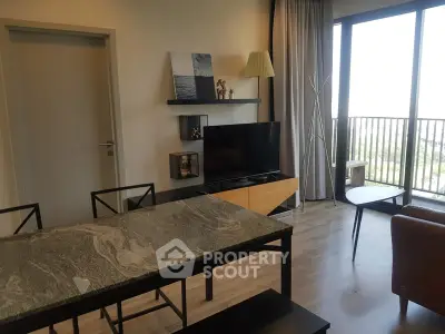 Modern living room with stylish decor and large windows offering natural light and a view.