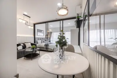 Modern open-plan living room with stylish decor and glass partition