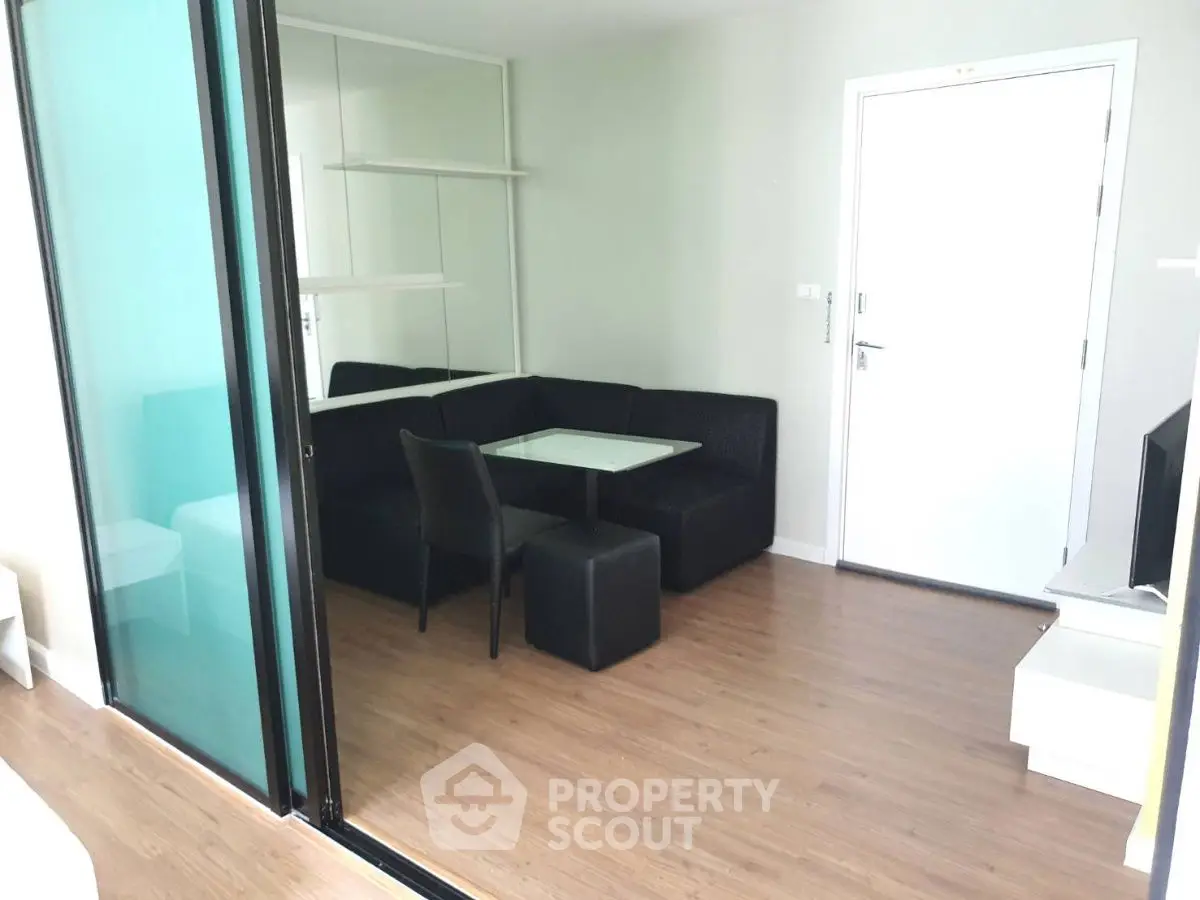 Modern apartment interior with sleek dining area and glass partition