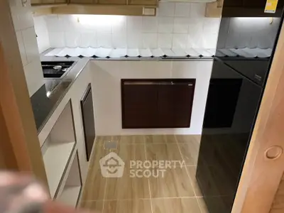 Compact kitchen with modern appliances and wooden flooring